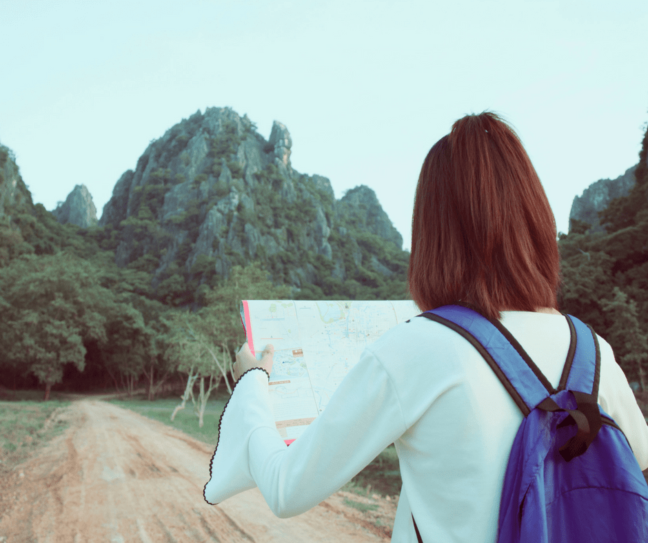 woman walking looking at map